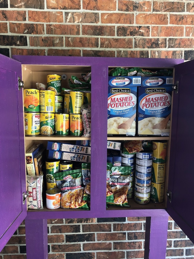 Cabinet filled with non-perishable food items.
